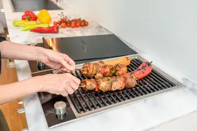 a person is cooking food on a grill at Artful City Loft with Rooftop Terrace, Near Beach in Chania Town