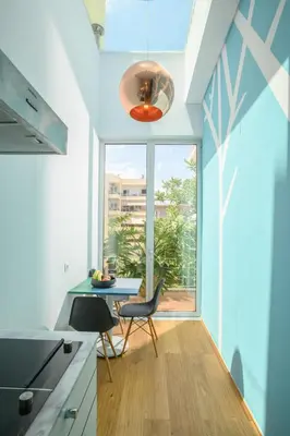 a kitchen with a table and chairs and a window at Artful City Loft with Rooftop Terrace, Near Beach in Chania Town