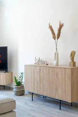 a living room with a wooden cabinet and a tv at Georginas home in city center in Chania Town