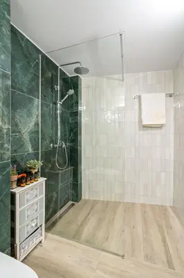 a bathroom with a shower with green tiles at Georginas home in city center in Chania Town