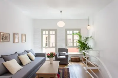 a living room with a couch and a chair at House of Sirri in Chania Town