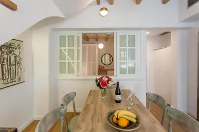 a dining room table with bananas and a bottle of wine at House of Sirri in Chania Town