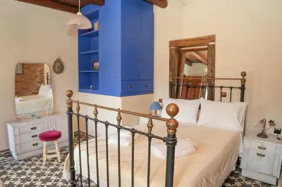 a bedroom with a bed and a blue cabinet at Traditional Villa with pool in Sfakia in Ímbros