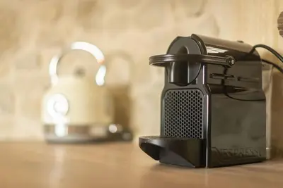 a black appliance sitting on top of a table at Fanouria's home in Kalleryianá