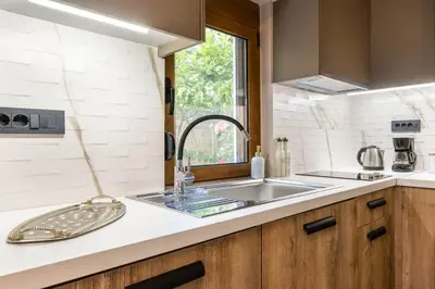 a kitchen counter with a sink and a window at Eva Cozy Apartment in Chania Town