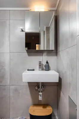 a bathroom with a white sink and a mirror at Eva Cozy Apartment in Chania Town