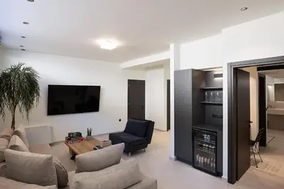 a living room with a couch and a chair and a television at Villa Kafkales Maleme - Heated Pool in Maleme