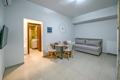 a living room with a table and a couch at A & G Apartments in Kolymvari