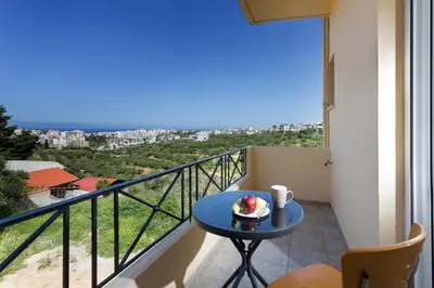 a room with a table with a cake on a balcony at Kds Overlooking Chania in Chania Town