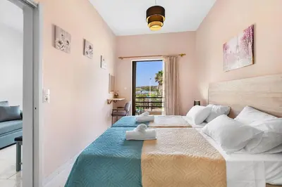 a bedroom with a large bed with towels on it at Sun Beach Apartments in Chania 09 11 in Chania Town