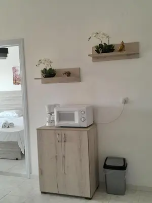 a microwave sitting on top of a cabinet in a room at Sun Beach Apartments in Chania 09 11 in Chania Town