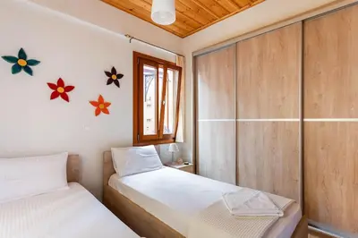 a bedroom with two beds and a window at Cozy house in the old town in Chania Town
