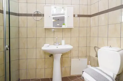 a bathroom with a sink and a toilet at Kristina Stelios Apartment in Plataniás