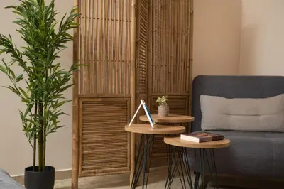 a living room with a couch and a table with a lamp at Harmony Apartment in Chania in Chania Town