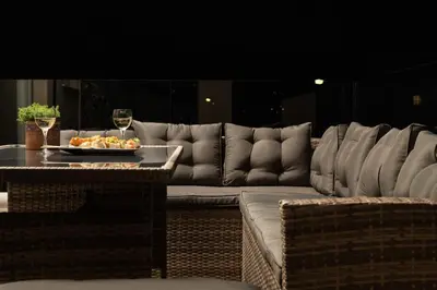 a living room with a couch and a table with a glass of wine at Harmony Apartment in Chania in Chania Town