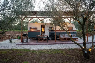 a camper with a picnic table and a grill at Onar Camper in Liyidhés