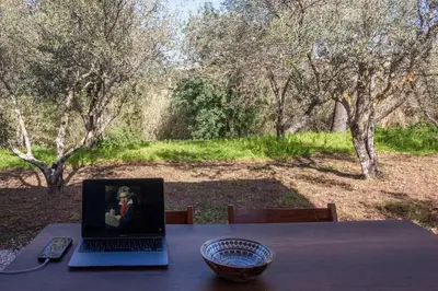 a laptop sitting on a table with a bowl on it at Onar Camper in Liyidhés