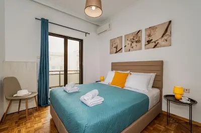 a bedroom with a bed with towels on it at Central apt. with parking - 3 min from old port in Chania Town
