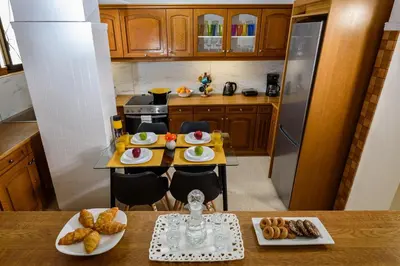 a kitchen with a table with plates of food on it at Central apt. with parking - 3 min from old port in Chania Town