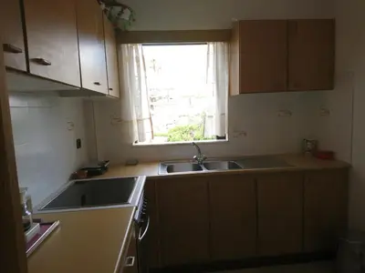 a small kitchen with a sink and a window at Sunny family apartment in Chania close to the sea in Chania Town