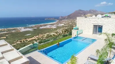 a swimming pool with a view of the ocean at Nafsika Xenia - Ariti Villa in Plátanos