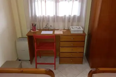 a desk with a red chair next to a window at Giannis Traditional House in Vamos