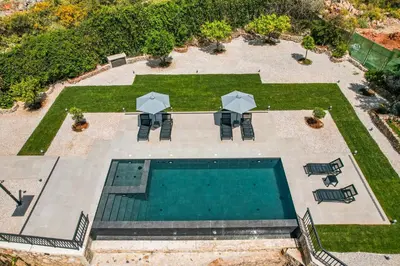 an overhead view of a pool with chairs and umbrellas at Villa Recluso-3 bd luxury country villa, huge heated pool with hydromassage, individual bbq & large yard, mountain view in Maláxa