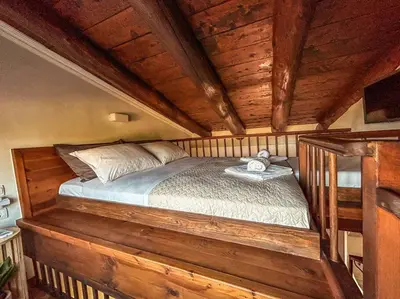 a bedroom with a wooden bed in a room at Villa Recluso-3 bd luxury country villa, huge heated pool with hydromassage, individual bbq & large yard, mountain view in Maláxa
