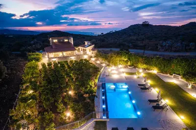 an aerial view of a villa with a swimming pool at night at Villa Recluso-3 bd luxury country villa, huge heated pool with hydromassage, individual bbq & large yard, mountain view in Maláxa