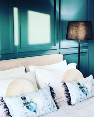 a bedroom with blue walls and a bed with pillows at Meliora Suites in Drapaniás