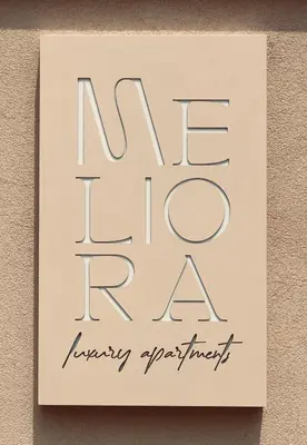 a sign that reads new fire rate hanging on a wall at Meliora Suites in Drapaniás