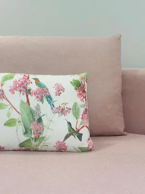 a pillow with birds and flowers on it on a couch at Meliora Suites in Drapaniás