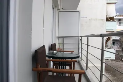 a balcony with a table and chairs on a building at Monica's Luxury Apartment in Chania Town