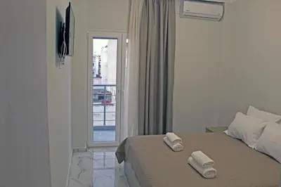 a bedroom with a bed with two towels on it at Monica's Luxury Apartment in Chania Town