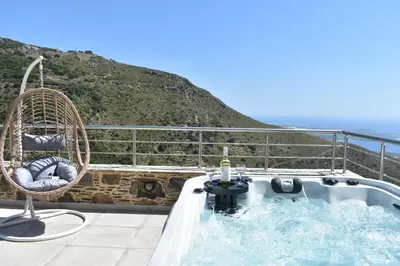 a jacuzzi tub on the balcony of a house at Vigla Apartments No.3 in AmigdhalokeFálion