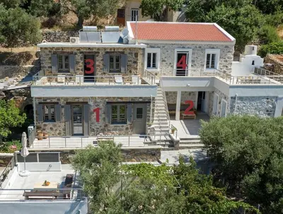 a large stone house with a red number eight at Vigla Apartments No.3 in AmigdhalokeFálion