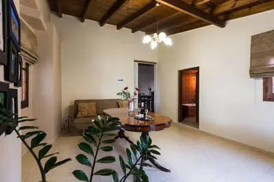 a living room with a table and a couch at Lefteris Holiday Home in Chania Town