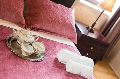 a tray with tea cups and a towel on a bed at Lefteris Holiday Home in Chania Town