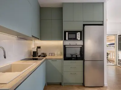 a kitchen with a sink and a refrigerator at Marita Luxury Apartment with parking space in Chania Town