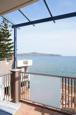 a balcony with a view of the ocean at Cozy Corner VS Beachfront in Stalos