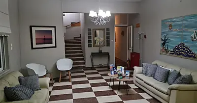 a living room with couches and a checkered floor at Cozy Corner VS Beachfront in Stalos