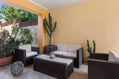 a patio with couches and chairs and a table at Private apartment in Kalamaki, Chania in Galatás