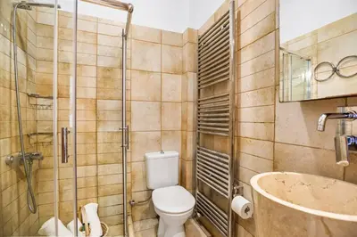 a bathroom with a toilet and a shower and a tub at Private apartment in Kalamaki, Chania in Galatás