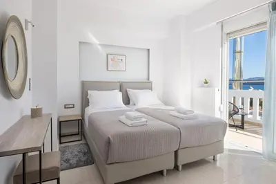 a white bedroom with a bed and a desk and a window at -Superior Maisonette Jacuzzi & Private Parking - Koum Kapi Mare Seaside in Chania Town