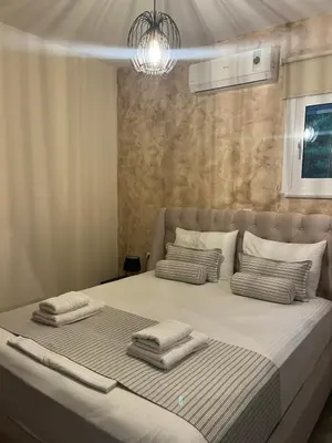 a bedroom with a large bed with two pillows at Amare suite in Perivólia