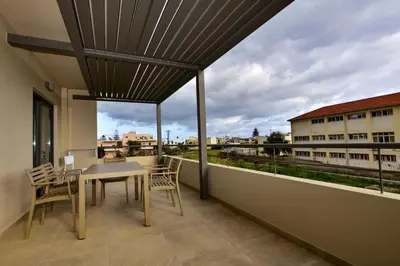 a balcony with a table and chairs and a view at Rosemary Apartments in Palaiochóra