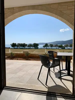 a patio with a table and chairs and a view at Christos Place-Paleochora in Palaiochóra