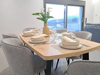 a wooden table with chairs and a vase on it at Christine luxury villa in Kolymvari