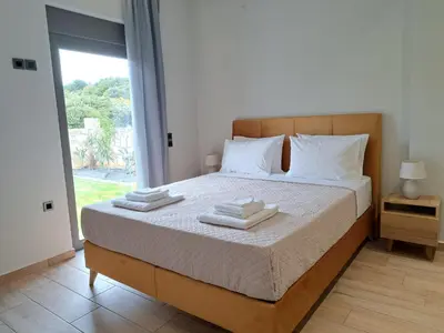 a bedroom with a bed with two towels on it at Christine luxury villa in Kolymvari