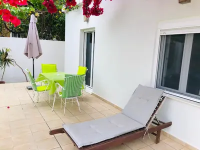 a patio with a table and chairs and a umbrella at Stamatias Home, fully equipped cottage 5 minutes from the sea in Chania Town